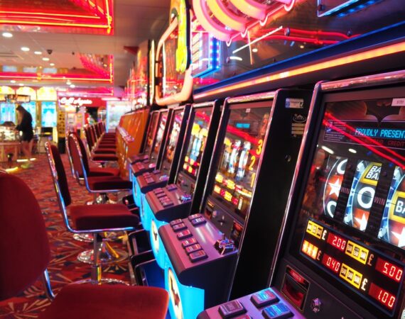 arcade machine with red and white chairs