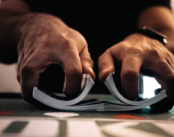 person wearing silver ring on macbook pro