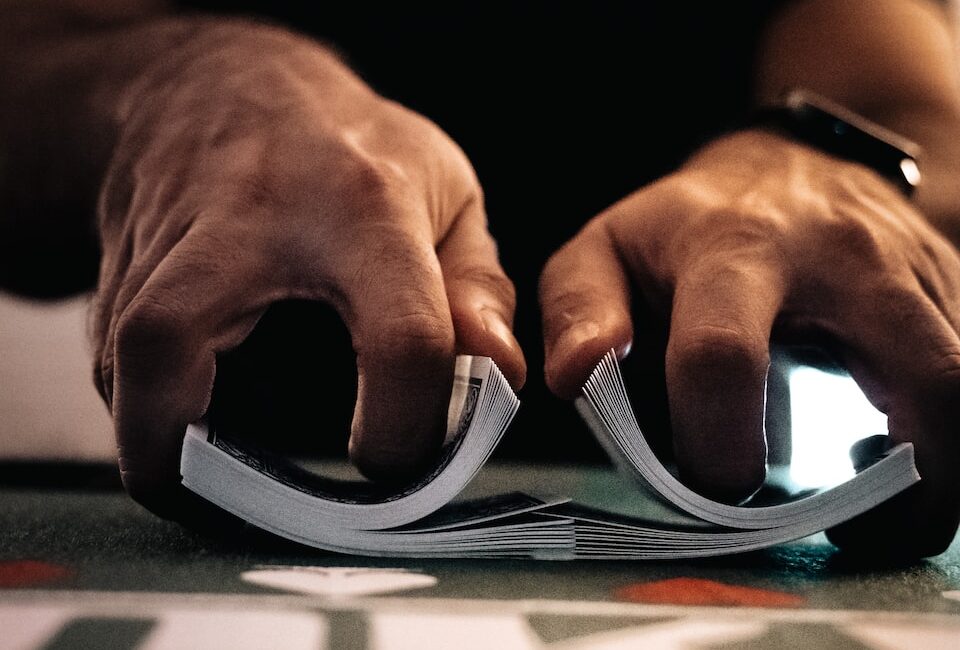 person wearing silver ring on macbook pro